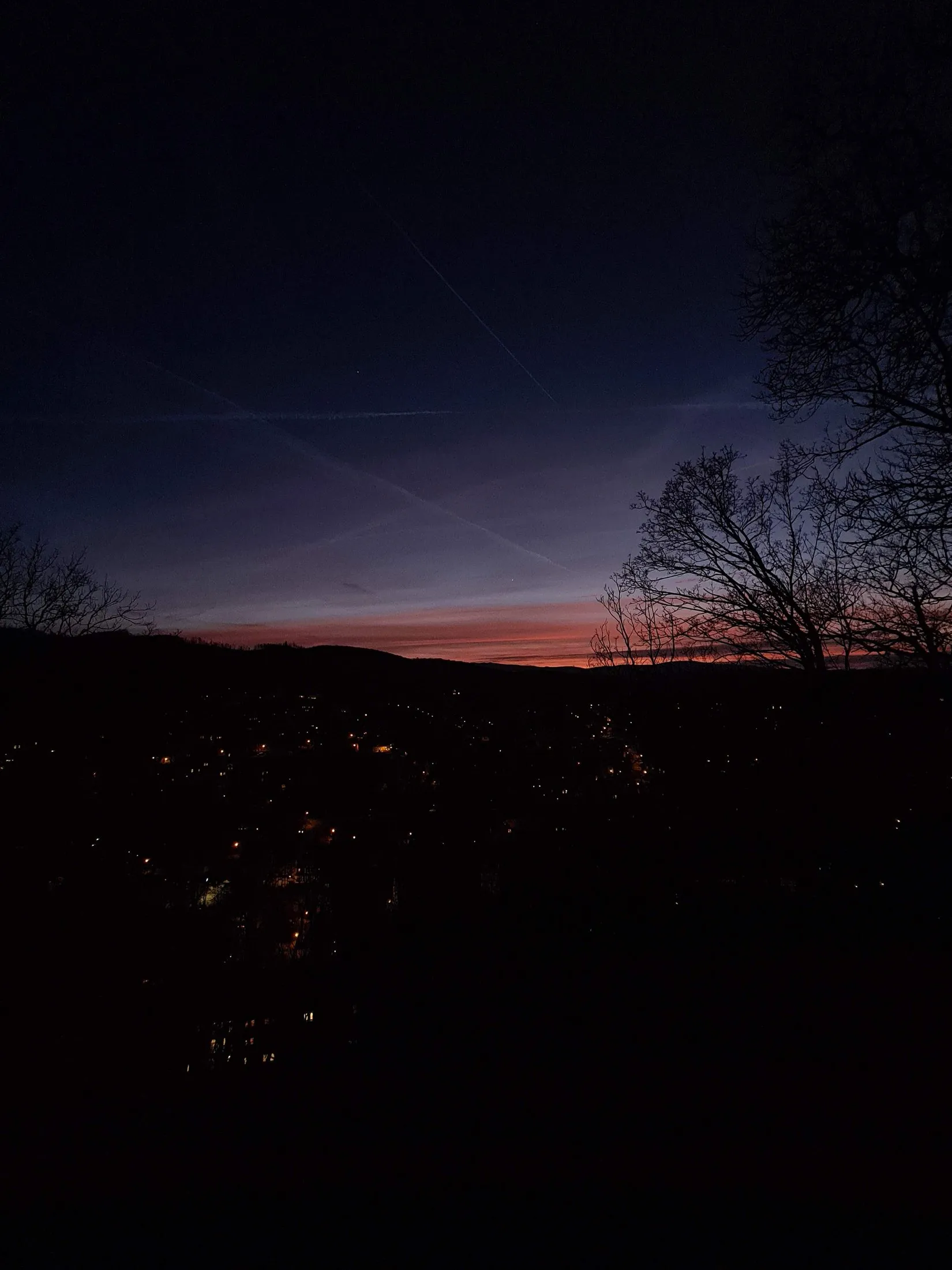 A thin band of dusk above a dark horizon
