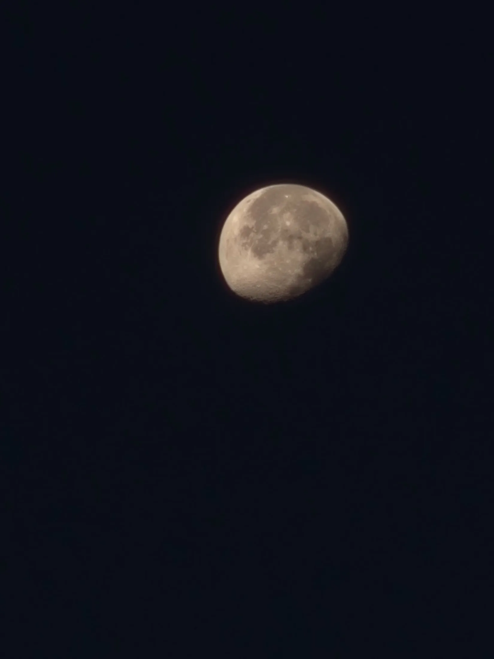 The moon in a dark morning sky