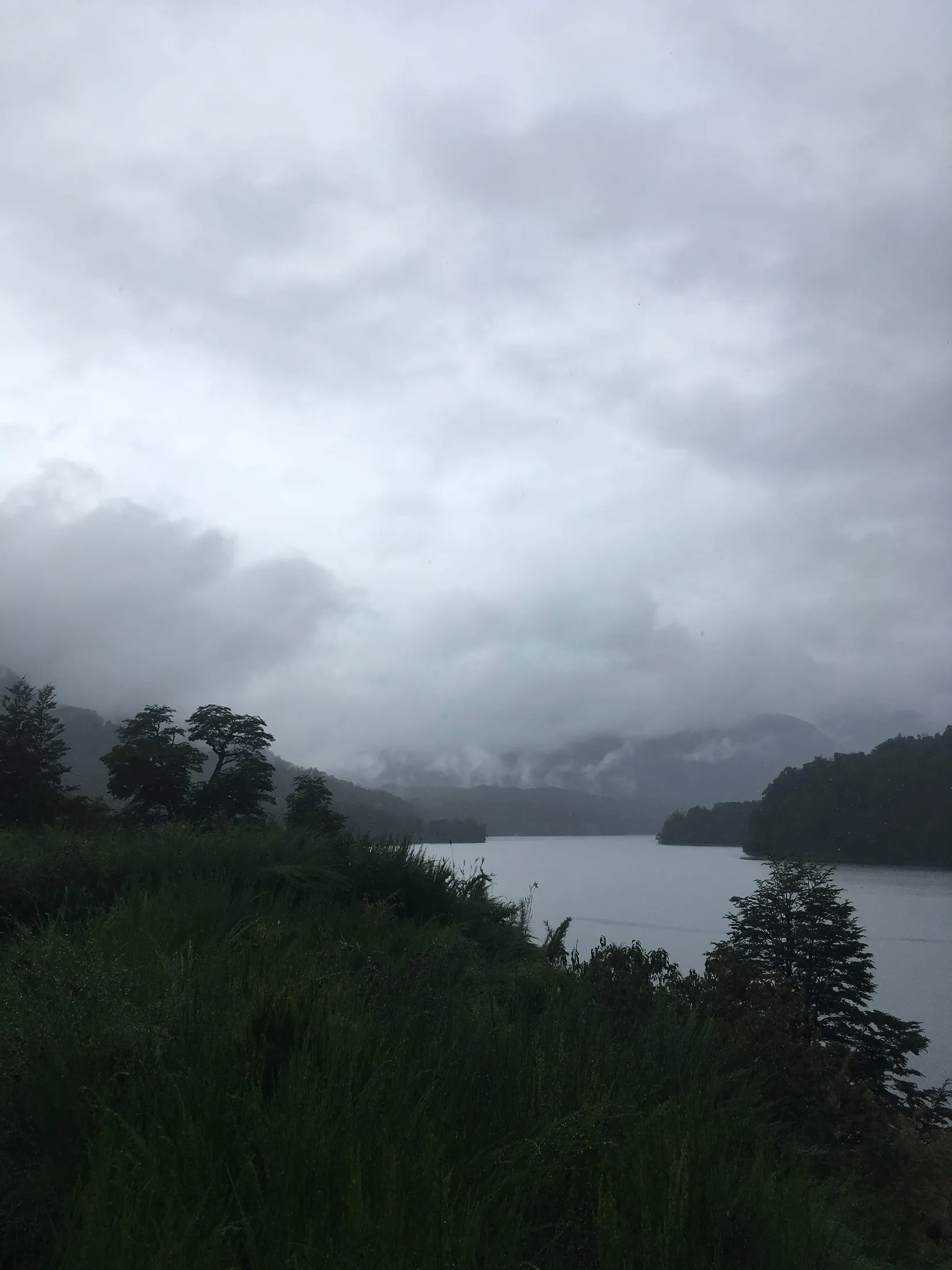 Cloud over a lake in the forested hills